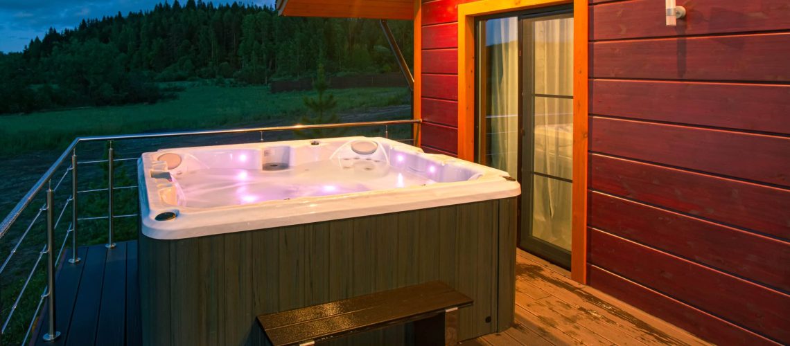 The,Illuminated,Hot,Tub,Is,Filled,With,Water.,Spa,Treatments